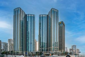 um grupo de edifícios altos em uma cidade em Orange Apartments em Chengdu