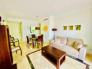 a living room with a couch and a table at Roda Golf. Poolside apartment in Murcia