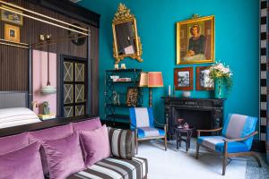 a bedroom with blue walls and a bed and a fireplace at PALAZZO ROMA in Rome