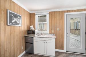 a kitchen with a sink and a microwave at Waters View Inn in South Haven