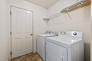 a white laundry room with a washer and dryer at Charming Private Twnhome w/ Large Fenced Yard (58) in Meridian