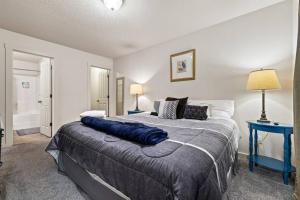a bedroom with a large bed with a blue table at Charming Private Twnhome w/ Large Fenced Yard (58) in Meridian