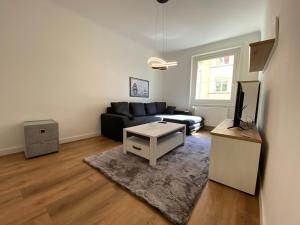 a living room with a couch and a table at Schöner Wohnen in Stuttgart Ost in Stuttgart