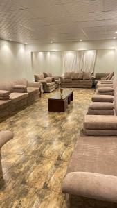 a large living room with couches and a table at إستراحة المزرعة in Abha