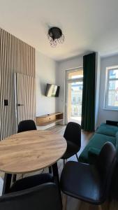 a living room with a table and chairs and a couch at CityCenterApartments/M32/6 in Bielsko-Biała