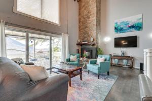 a living room with a couch and chairs and a fireplace at Lakefront California Escape with Deck and Boat Dock! in Clearlake