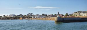 a body of water with a beach and buildings at Le Boisvinet in Saint-Gilles-Croix-de-Vie