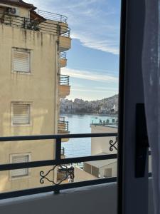 a view of the water from a window of a building at Comfort Apartments Promenade in Sarandë