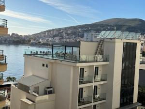a building with a view of the water at Comfort Apartments Promenade in Sarandë