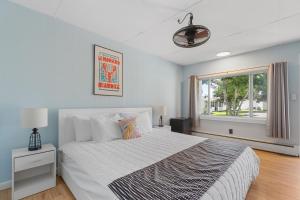 a bedroom with a large bed and a window at The Beaches Guestrooms and Cottages in Wells