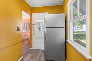 a refrigerator in a room with a window at The Beaches Guestrooms and Cottages in Wells