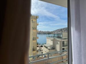 a view of the water from a window at Comfort Apartments Promenade in Sarandë