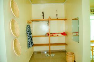 a room with shelves on the wall at Karisimbi Cave Resort in Ruhengeri