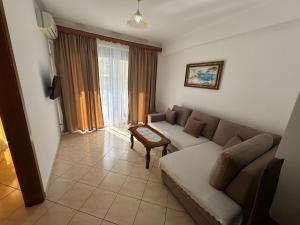 a living room with a couch and a table at Comfort Apartments Promenade in Sarandë