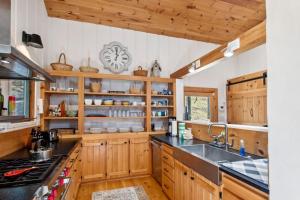 a kitchen with wooden cabinets and a sink at Bluff View Farm in West Jefferson