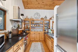 a kitchen with wooden cabinets and a stainless steel refrigerator at Bluff View Farm in West Jefferson +43 photos