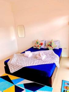 a small bedroom with a blue bed in an airplane at เดอะซันเซ็ท บางแสน in Chon Buri