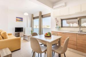 a kitchen and living room with a table and chairs at Iriana's Apartments in Center in Chania