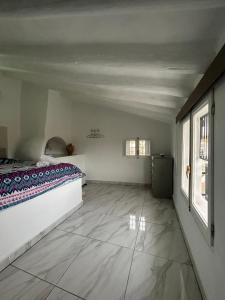 a bedroom with a bed and two windows at The Crystal Cave in Zújar