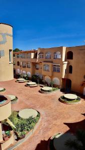 a courtyard of an apartment building with a bunch of tables at Reef Mondello Apartment in Palermo