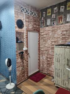 a room with a door and a brick wall at 108 Quiet and Cozy apartment w/free Wi-Fi in Bangkok
