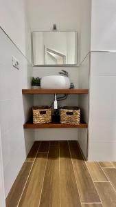 a bathroom with a sink and a mirror at Reef Mondello Apartment in Palermo +28 photos