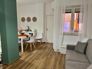 a living room with a couch and a table at Reef Mondello Apartment in Palermo