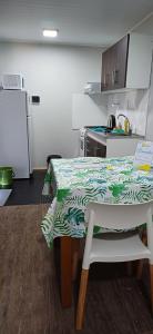 a small kitchen with a table and a refrigerator at Alojamientos Dulce Luz in Villa Elisa