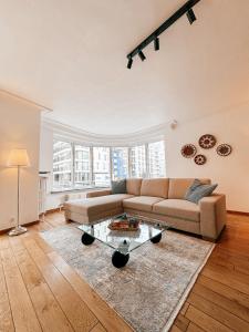 a living room with a couch and a table at Appartement Montfleuri in Ostend