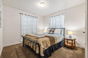 Un dormitorio con una cama y dos lámparas sobre una mesa. en Charming home w/ Fenced Yard On Quiet Street (98), en Meridian