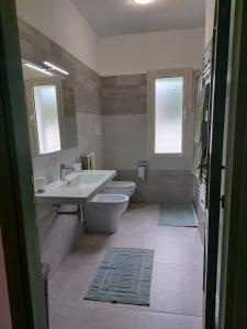 a bathroom with a sink and a toilet at Residenza Su Portu in Orosei