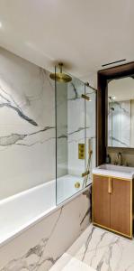 a bathroom with a shower and a sink and a mirror at Soho Mandarin in London