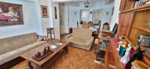 ein Wohnzimmer mit einem Sofa und einem Tisch in der Unterkunft Domum - The Comunist Apartment in Bukarest