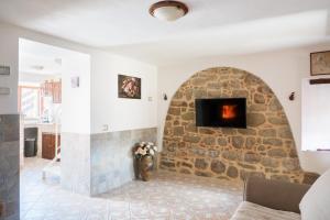 a living room with a stone fireplace at Casa Vacanze “Rocca dei sogni” in Aquasanta