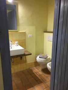 a bathroom with a white sink and a toilet at Casale del Rosmarino - Monolocale Melograno in Montefiascone