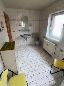 a bathroom with a sink and a toilet at Ferienwohnung Gut-Wattberg in Hofgeismar