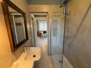 a bathroom with a shower and a sink and a mirror at Villa Giorgio 1 relax in pineta in Bibione +21 photos