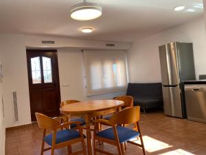 a kitchen with a table and chairs and a refrigerator at Can Pirrot Salitja in Salitja