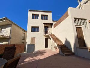 a white building with a staircase leading up to it at Can Pirrot Salitja in Salitja