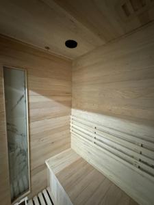 a wooden sauna with a bench in a room at Stay Inn Express in Cambridge