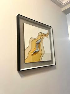 a picture hanging on a wall in a room at Hacienda Residence - Solar Energized in Yaoundé