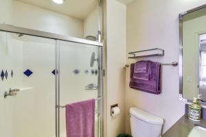 a bathroom with a glass shower stall and purple towels at Lake Access & Hot Tub: Pet-Friendly Arnold Home in Arnold +24 photos