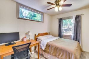 a bedroom with a bed and a desk with a television at Lake Access & Hot Tub: Pet-Friendly Arnold Home in Arnold