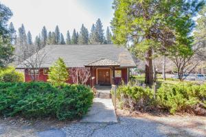 a home with a red house with a tree at Lake Access & Hot Tub: Pet-Friendly Arnold Home in Arnold