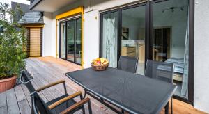 a black dining table and chairs on a patio at Moseltraum in Bruttig-Fankel