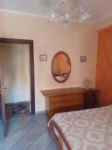 a bedroom with a bed and a mirror on the wall at Holiday Homes in Campofelice di Roccella