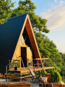 a tiny house with a blue roof and a fence at A-Frame Rest-Art in Batumi