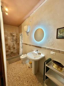 a bathroom with a sink and a toilet at Villa Sibilla in Barga