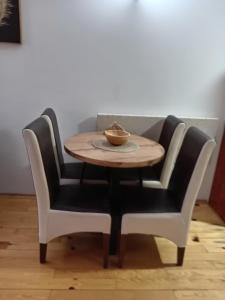 a table with two chairs and a bowl on top at Simic Apartmani Tara in Kaludjerske Bare