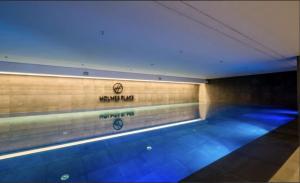 a swimming pool with blue lights on the wall at ~ Luxury Downtown Haven in Wrocław